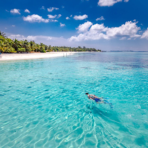 A couple snorkel in the Maldives
